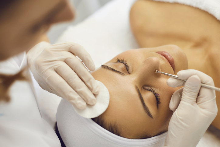 Woman receiving a professional facial treatment in a spa.