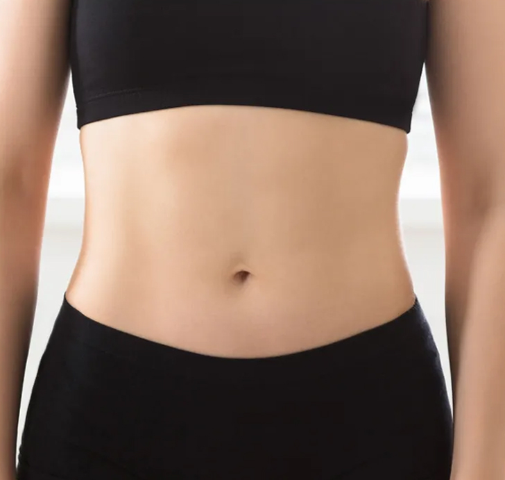 Person in black sportswear showing toned midsection.