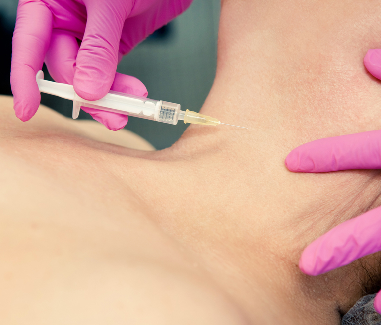 A person receiving a cosmetic injection in the neck area by gloved hands.