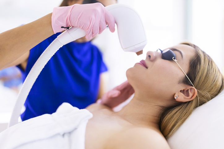 A woman receiving a laser skin treatment in a clinic.