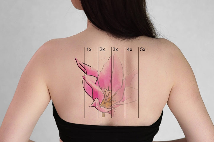 A woman with a layered pink flower tattoo on her back.