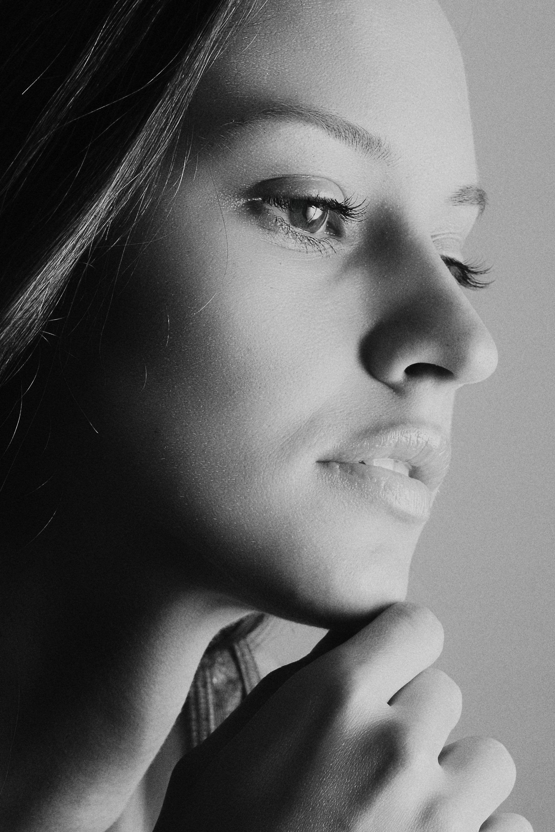 A contemplative person gazes thoughtfully in a black and white portrait.